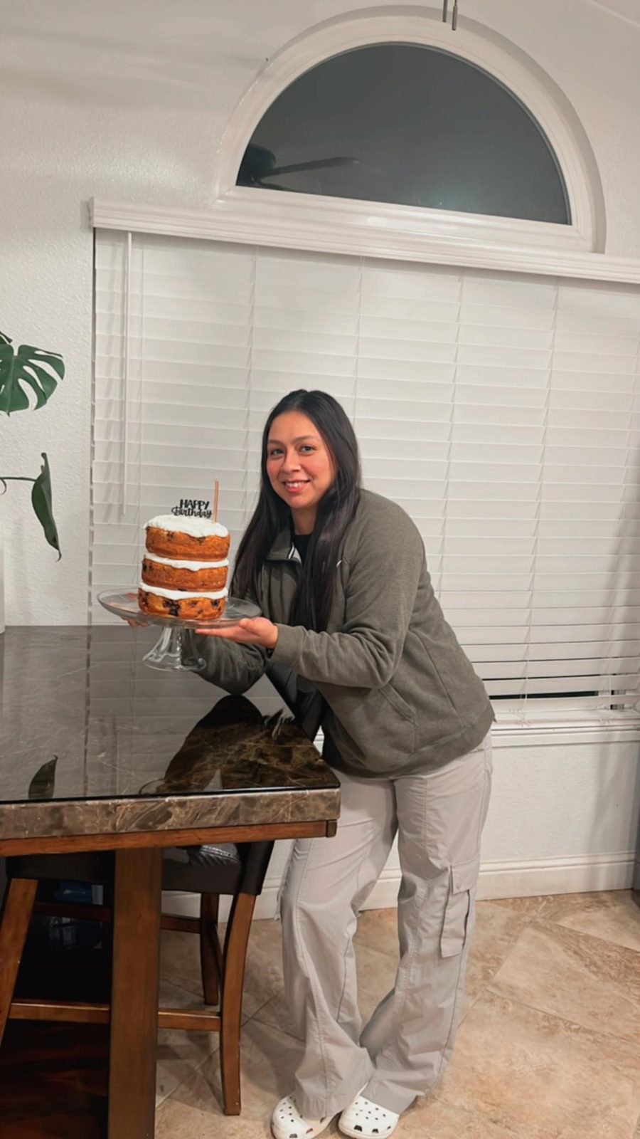 Nancy holding a birthday cake she baked